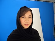 ローブに身を包んだ西原、砂漠という設定で黒い布は熱を吸収して暑そう。