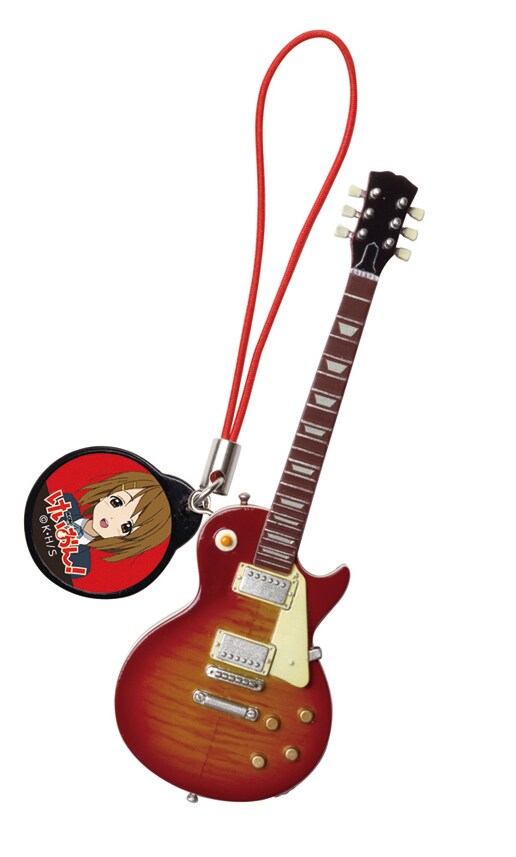 「ギー太」の愛称でお馴染み、レスポールタイプの唯モデルストラップ付きバージョン。（c）かきふらい・芳文社／桜高軽音部