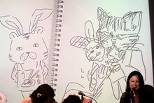 スクリーン左がコンドウアキ、右がヤマザキマリの描いた「TIGER & BUNNY」。世界中の「タイバニ」ファンに見せたい仕上がりだ。