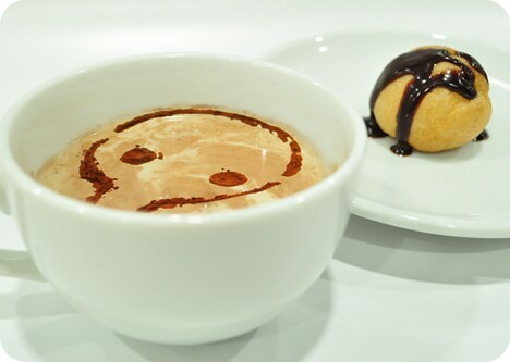 コーヒーに使徒がラテアートされた「第4の使徒のラテ」は、ミニシュークリーム付き。(C)khara