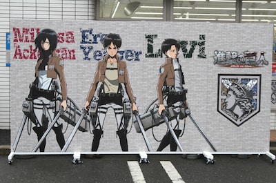 エレン、リヴァイ、ミカサが並んだ「巨大ウォール」。裏面には3人の中から1人をフィーチャーしたイラストがあしらわれている。