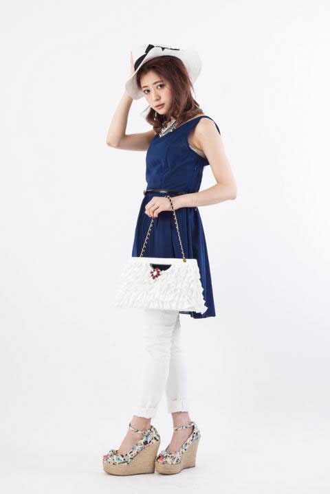 「怪盗キッドモデルパーティーバッグ」をモデルが持った様子。(c)青山剛昌/小学館・読売テレビ・TMS 1996