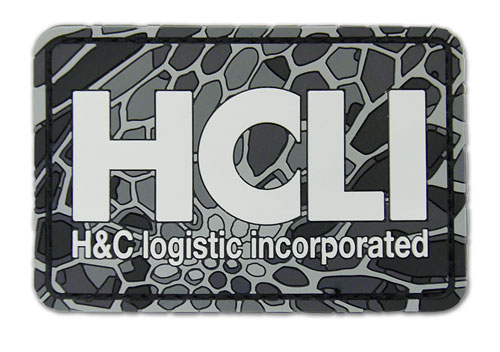 「ヨルムンガンド」の「HCLI PVCパッチ」。コミックマーケット89では「HCLI M-65ジャケット」とのセットでの取り扱いとなる。