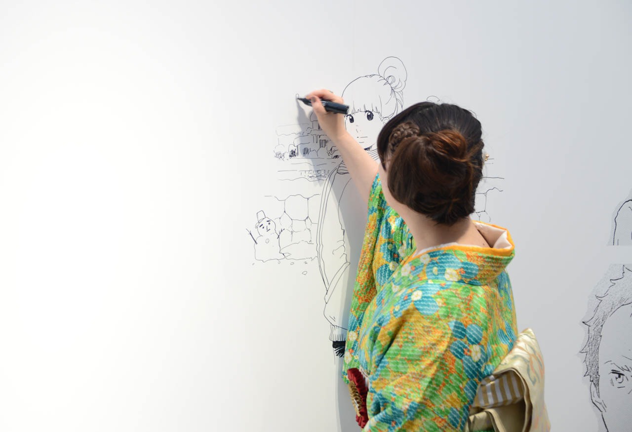 壁面に即興でイラストを描く東村アキコ。