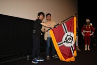 イベント最後には、谷口Pから小形Pに「THE ORIGIN」から「サンダーボルト」が繋がっていくようにと、ジオン軍旗の授与が行われた。