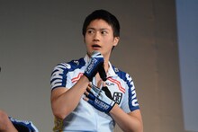 自分の筋肉に手を当てる、泉田塔一郎役の青木空夢。