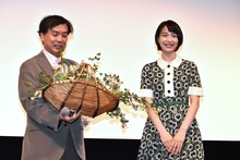 のん（右）から花を受け取る片渕須直監督。