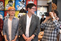 報道陣を撮影する沢田ユキオ（右）。