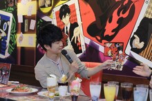 フードを注文するともらえるコースターを手に取った福山潤。