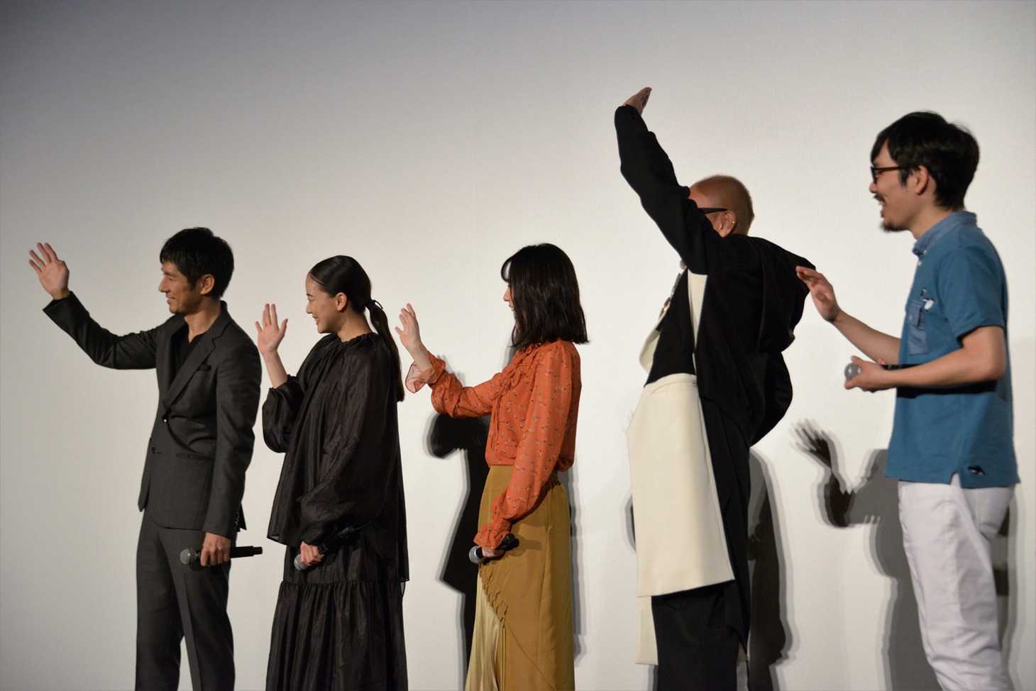 生中継のカメラへ手を振る登壇者たち。
