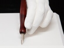 板垣巴留の手をかたどった石膏製モニュメントと、愛用ペン。