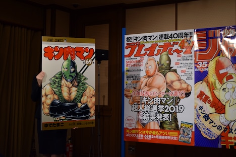 「キン肉マン」69巻と、週刊プレイボーイ22号の表紙を拡大したパネル。