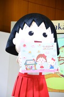 コラボビジュアルをアピールするまる子。