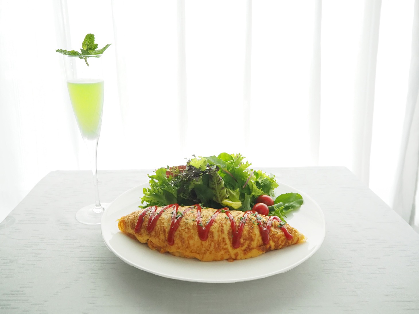 「朝食・夕食付きプラン」のカクテルとオムライス。