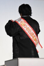 TVアニメ第2期決定を知らせるたすきを見せる榎木淳弥。