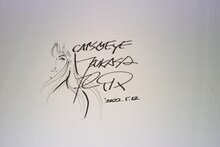 北条司が「キャッツ♥アイ40周年記念原画展 ～そしてシティーハンターへ～」に来場し、壁に書いたサイン。