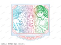 会場の「トレーディング 原作コマ アクリルスタンド（全10種）」BOX購入特典に用意された「七海るちあ 表紙イラスト スクエア缶バッジ イベント限定特典」。