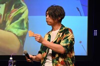 「ビックリマン」を開封し、ウエハースを食べる小西克幸。