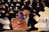 くま工場長のぬいぐるみを抱く作田ハズム監督。