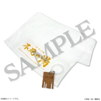 「真船一雄 漫画家40周年記念 スーパードクターKシリーズ原画展 Kの系譜」で販売されるN県T村の「不死の湯」をイメージしたタオル&キーホルダーのセット。