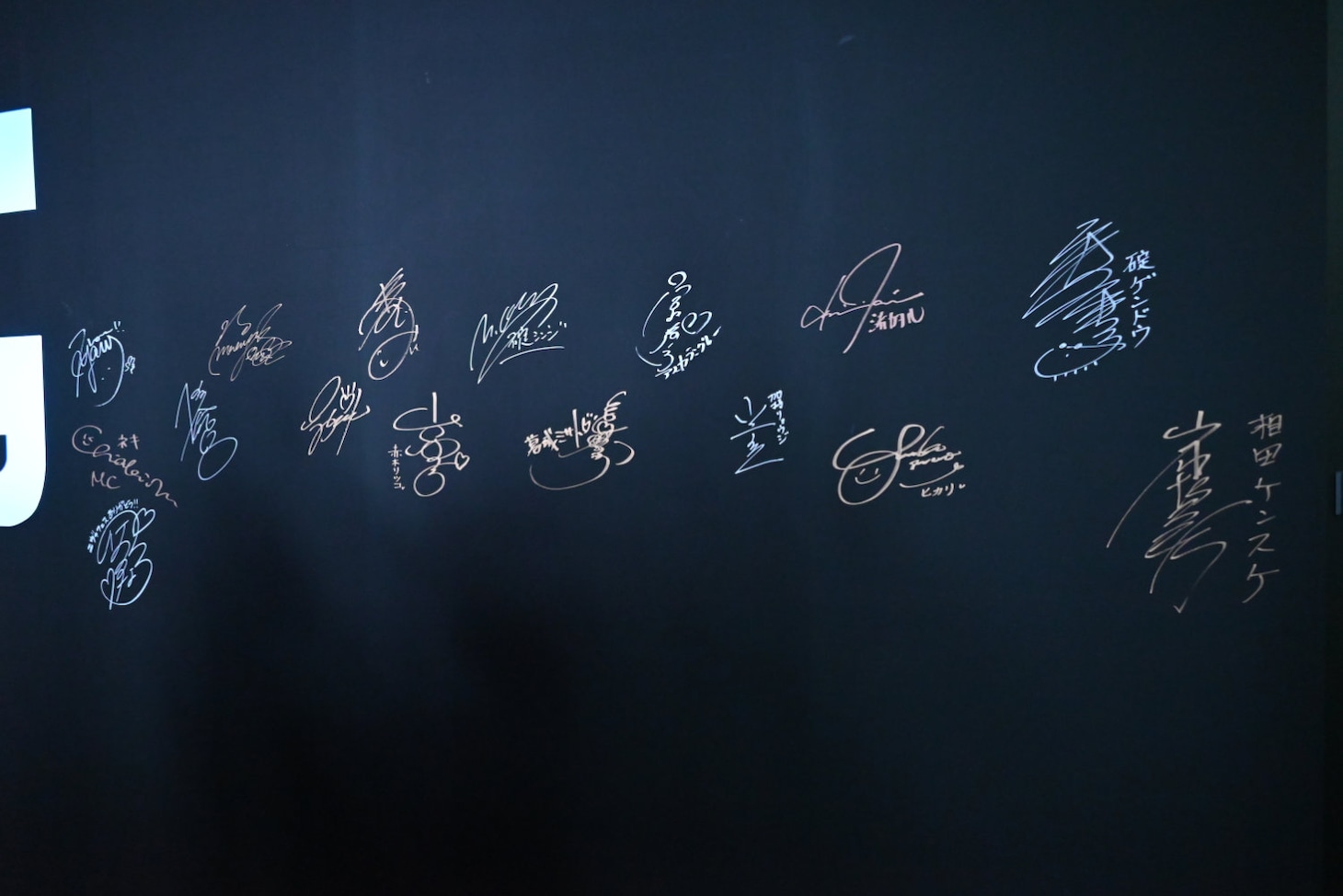 サインウォールに書かれたキャストたちのサイン