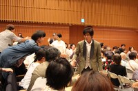 美瑛町の町民と交流する佐藤浩市（中央）。