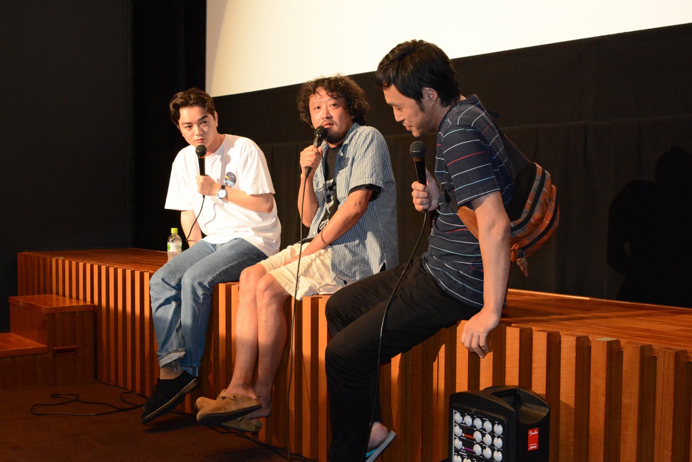 「ローリング」上映後のトークイベントにて、「高いところに登るのは失礼なので」と舞台に腰掛けて話す染谷将太、川瀬陽太、冨永昌敬。