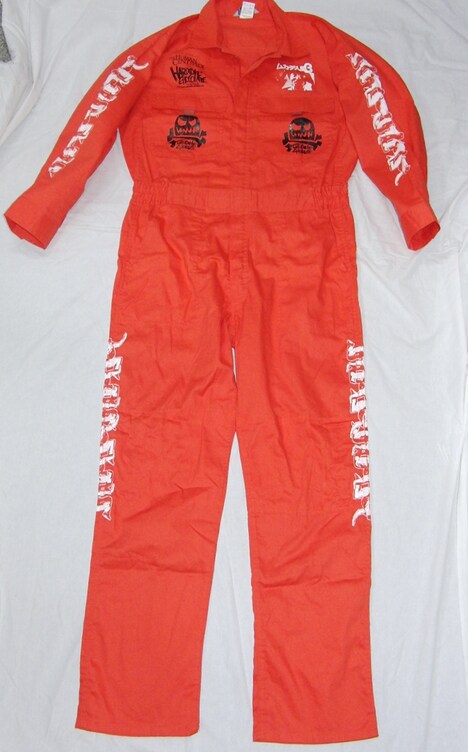 「ムカデ人間3 -ジョージ・ブッシュ囚人服-（串刺しオレンジ）」表面