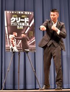 舞台上で右ストレートを繰り出す、WBA世界スーパーフェザー級王者の内山高志。
