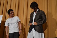 阪本順治（左）が原田芳雄の形見分けとしてもらったジャケットを試着する斎藤工（右）。