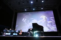 ステージでピアノを弾くYOSHIKI。