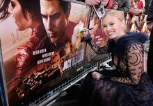 「ジャック・リーチャー NEVER GO BACK」ロンドンプレミアにて、ポスターにサインするダニカ・ヤロシュ。