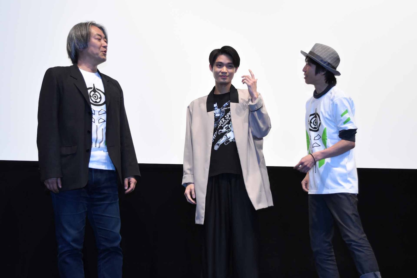 ポーズを相談する登壇者たち。