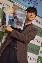 「吉沢亮 PHOTO BOOK『One day off』」より、お気に入りの1枚を掲げる吉沢亮。