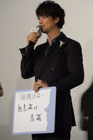 フリップに書いた回答を見せる斎藤工。