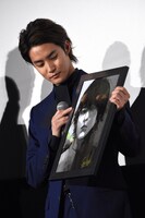 石田スイによるイラストを受け取った白石隼也。