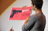 プレゼント用サウンドトラックLPに書かれたエドガー・ライトのサインを見せるアンセル・エルゴート。