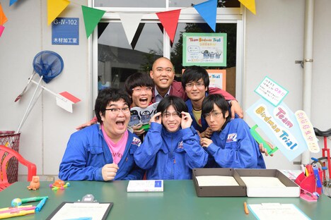 「トリガール！」撮影中のオフショット。人力飛行サークル“T.B.T”部員役のエキストラとナダル（上段中央）。