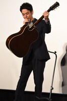 奥田民生のサイン入りギターを手にする妻夫木聡。