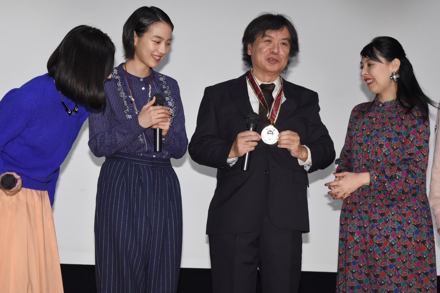 町山智浩が選ぶ、2016年町山大賞の受賞記念メダルを観客に見せる片渕須直監督。