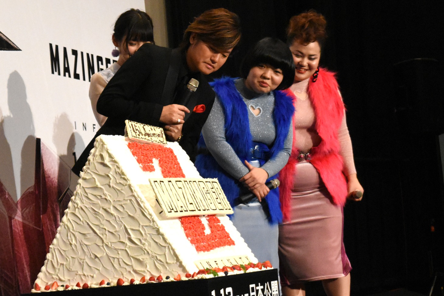 ケーキをのぞき込む森久保祥太郎（左）とおかずクラブ（右2人）。