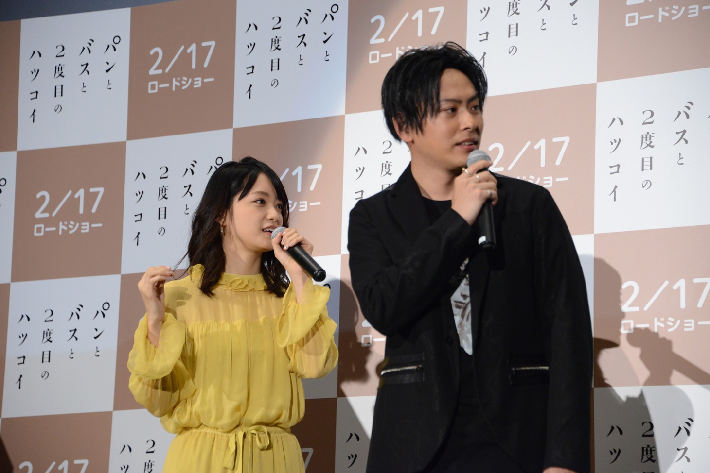 会場に運び込まれる特大バージョンの“くまさんパン”を見る深川麻衣（左）、山下健二郎（右）。