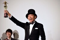 トロフィーを掲げる木梨憲武。