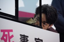 ツマフリと命名されたワニを観察する大谷亮平（奥）。