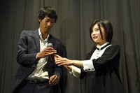 山本亜依（右）からマイクを受け取る柴田貴哉（左）。