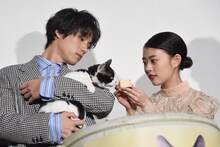 福士蒼汰（左）が抱くナナに猫用ミルクを薦める高畑充希（右）。