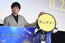 クロちゃん（右）の顔をパネルで隠す田中圭（左）。