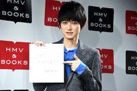 来年の抱負を書いた色紙を指差す本郷奏多。