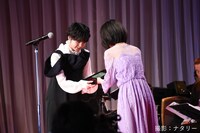 浜辺美波（手前）から表彰盾を受け取る平手友梨奈（奥）。