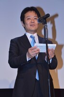 文化庁参事官の坪田知広。